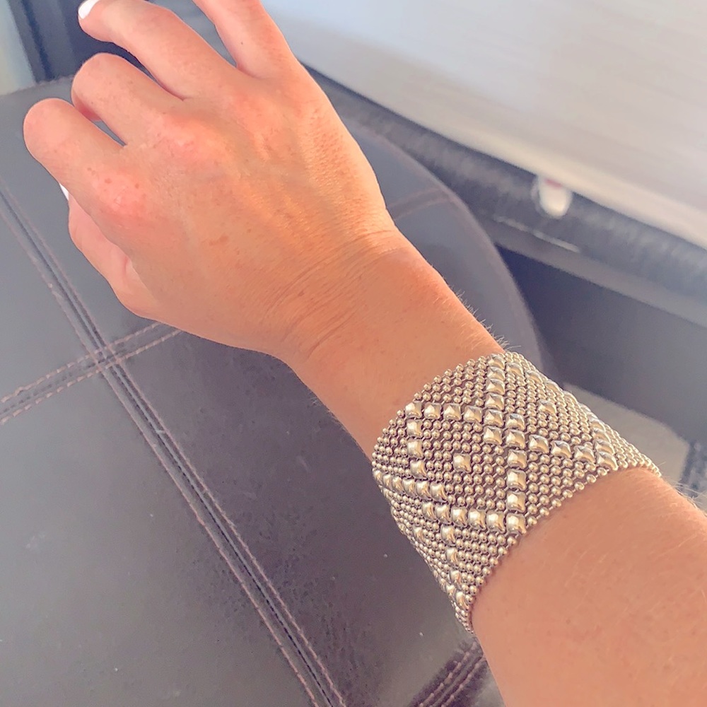 Metal slinky bangle bracelet with snap button.
